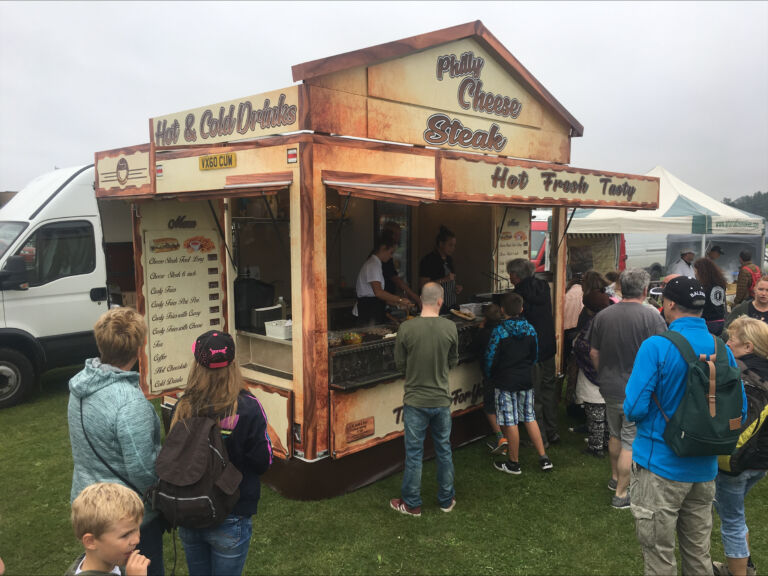 Visitors queuing at a hot food stall
