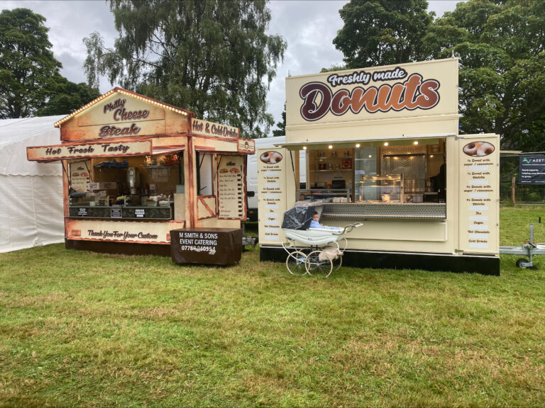 Doughnut and food trailers on the grass